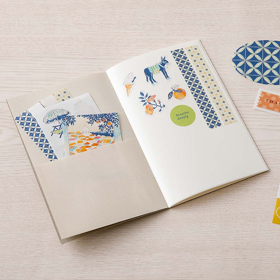 Sticker book with decorative stickers on a wooden surface