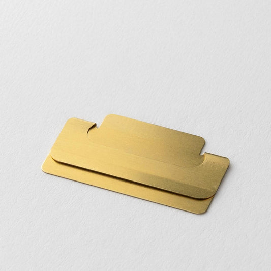 Close-up of a Midori Chiratto medium brass page marker