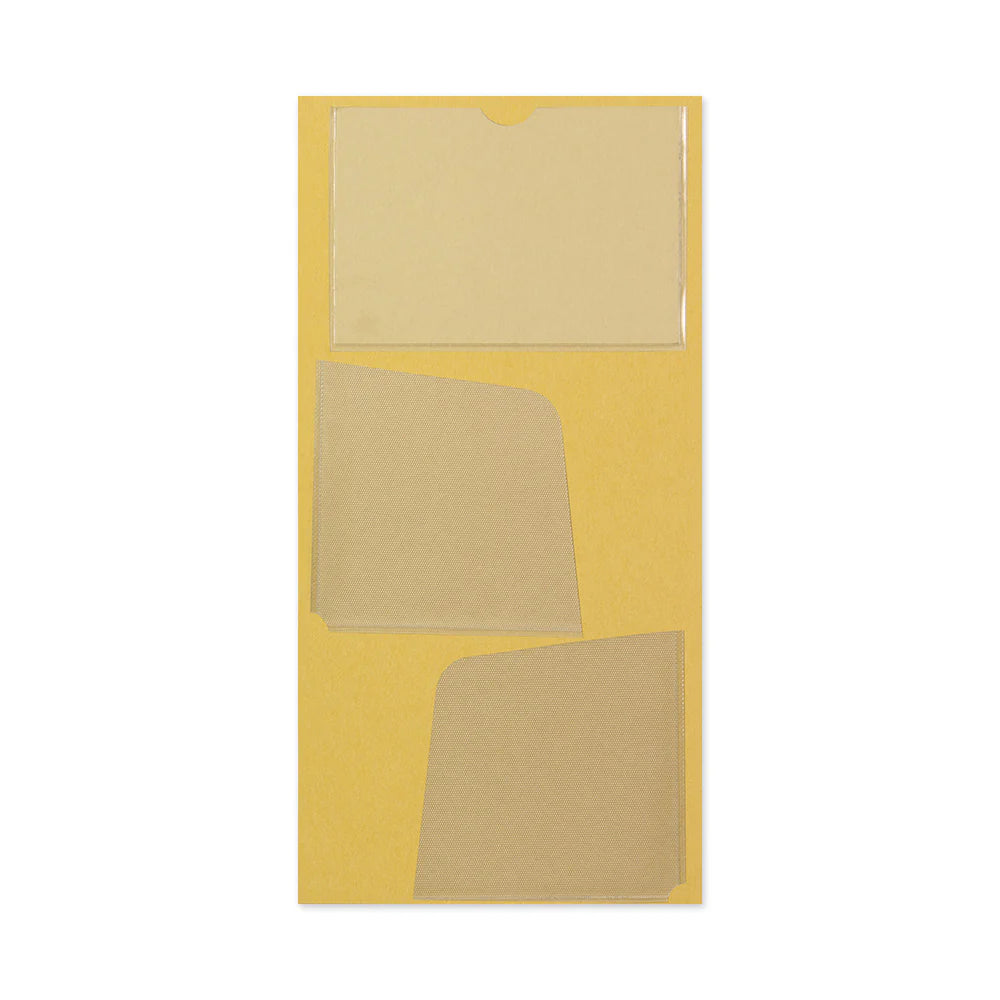 TRAVELER’S notebook self-adhesive pocket stickers with three clear PVC storage pockets for Regular Size notebooks.