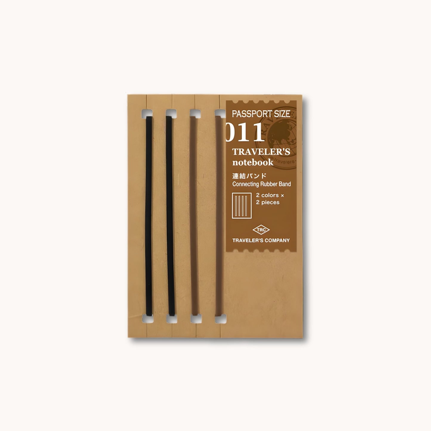 Set of TRAVELER’S notebook Passport Size Connecting Rubber Bands in black and brown – used to join multiple refills.