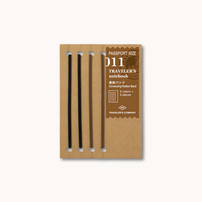 Set of TRAVELER’S notebook Passport Size Connecting Rubber Bands in black and brown – used to join multiple refills.