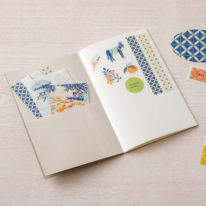Sticker book with decorative stickers on a wooden surface