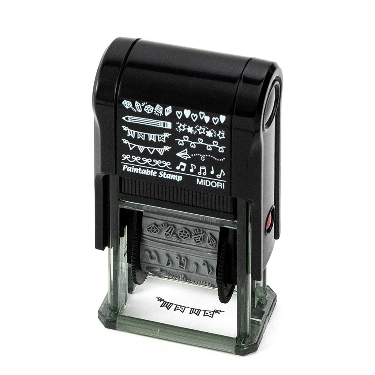 Midori Pre-Inked Paintable Stamp – 10 rotating decorative motifs including hearts, stars, ribbons and more. Waterproof black ink, no ink pad needed. Made in Japan.
