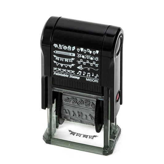 Midori Pre-Inked Paintable Stamp – 10 rotating decorative motifs including hearts, stars, ribbons and more. Waterproof black ink, no ink pad needed. Made in Japan.