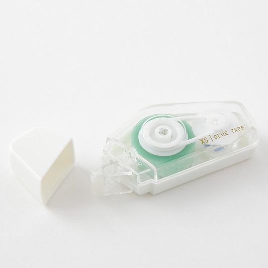 Clear tape dispenser with green tape on a white background