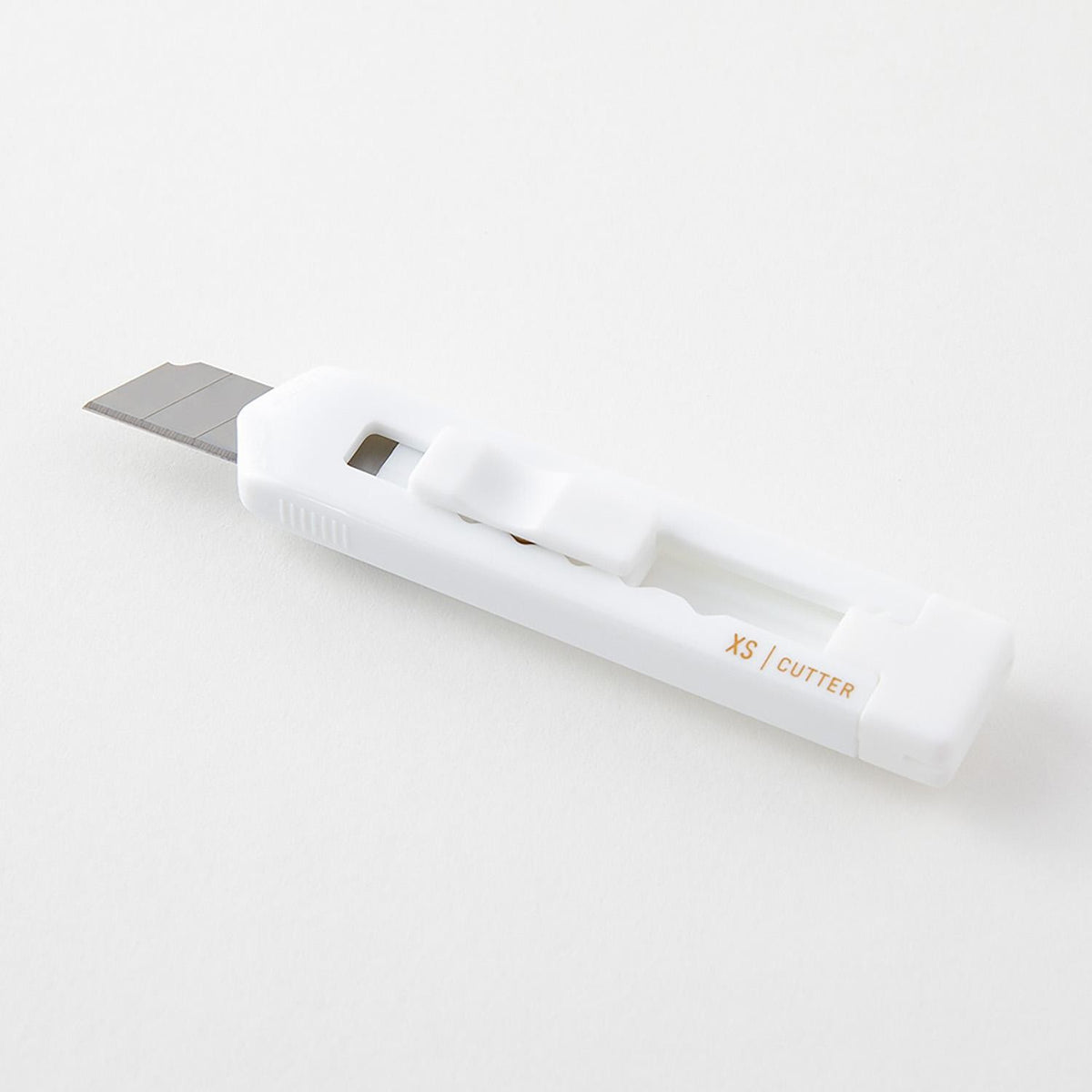 Midori XS white cutter with blade extended