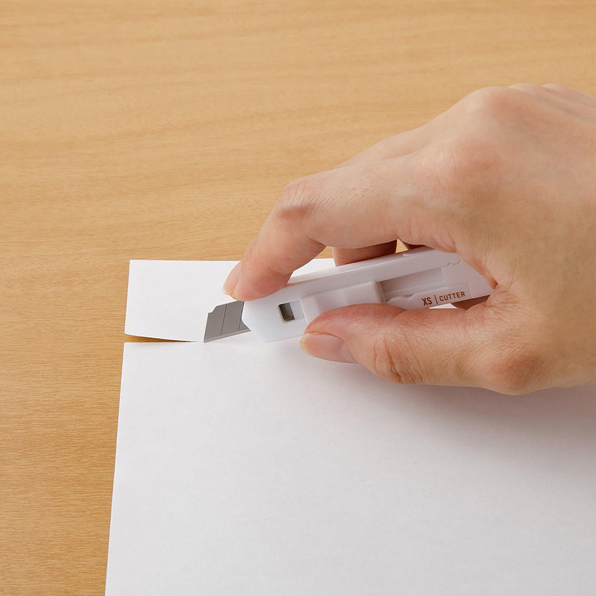 Midori XS white cutter held against paper