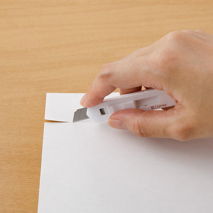 Midori XS white cutter held against paper