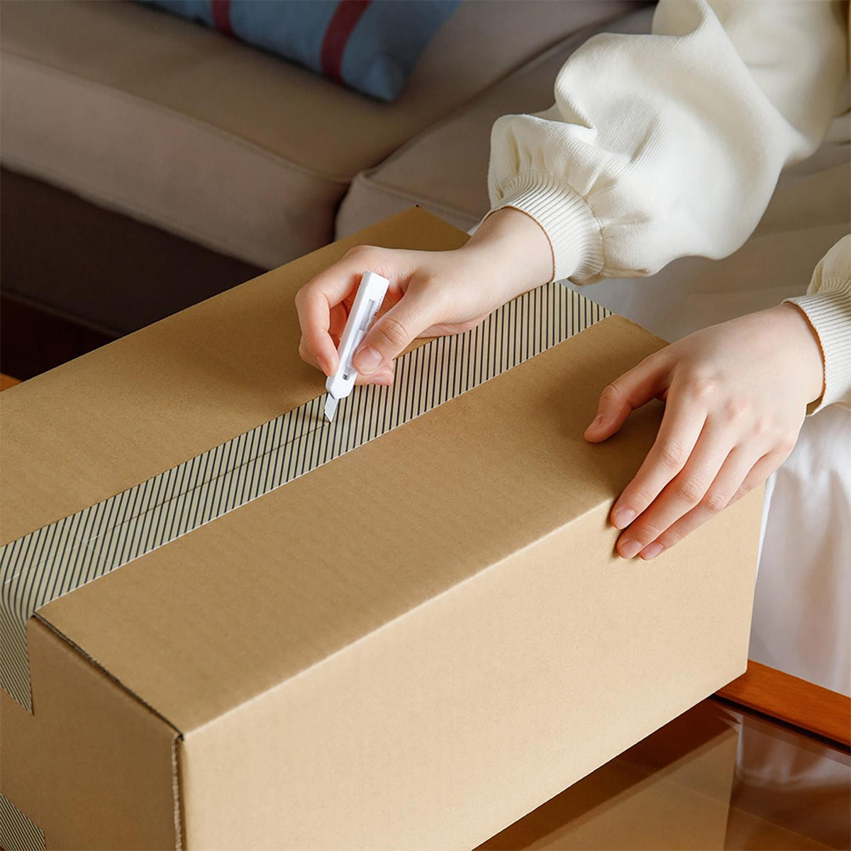 Midori XS white cutter cutting cardboard