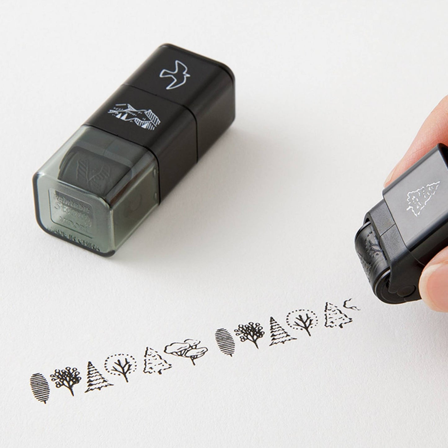 Midori roller stamp with mountain, tree and bird patterns, continuous pre-inked design, paintable Japanese stationery stamp