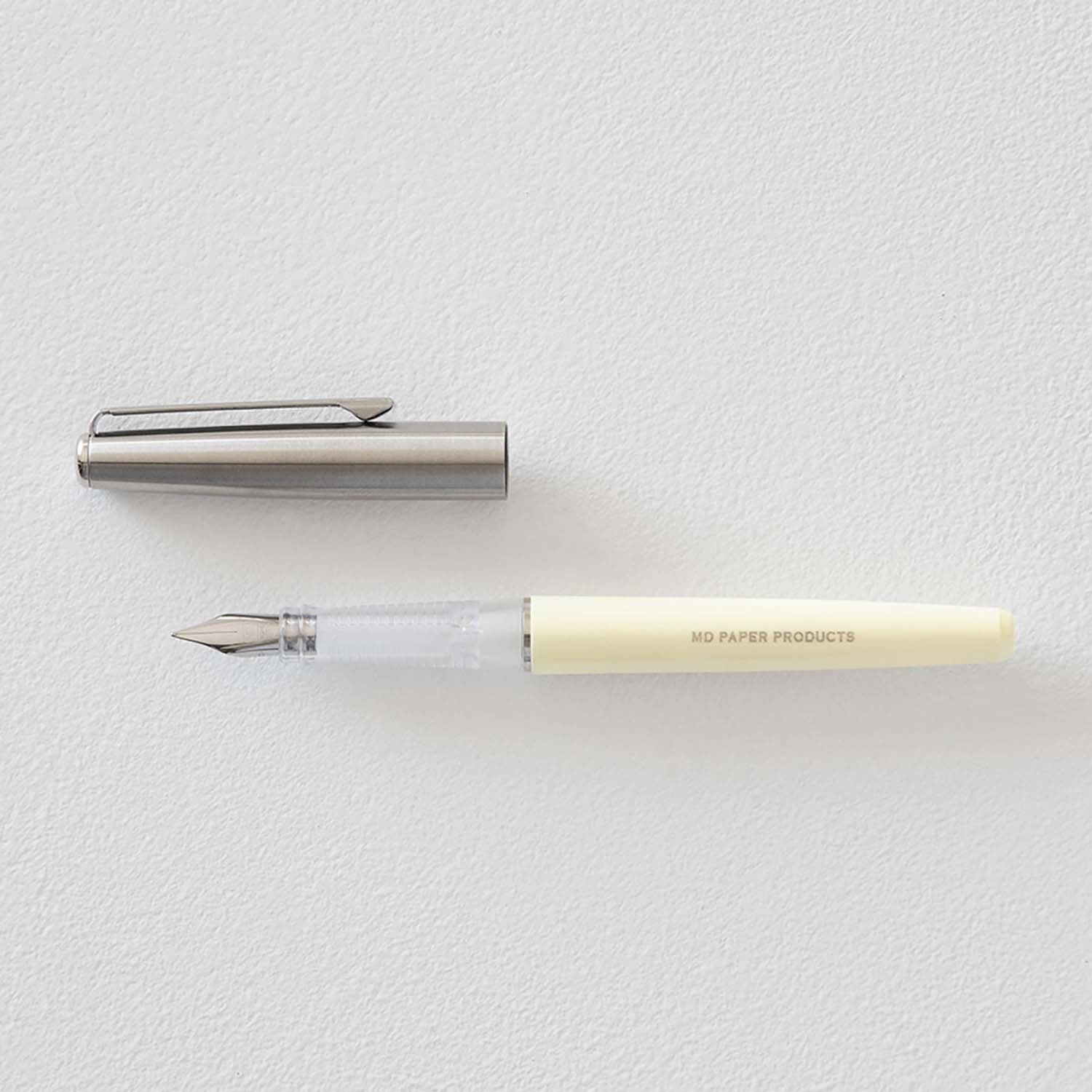 MD Product fountain pen with cream body, medium steel nib and black ink cartridge in presentation box
