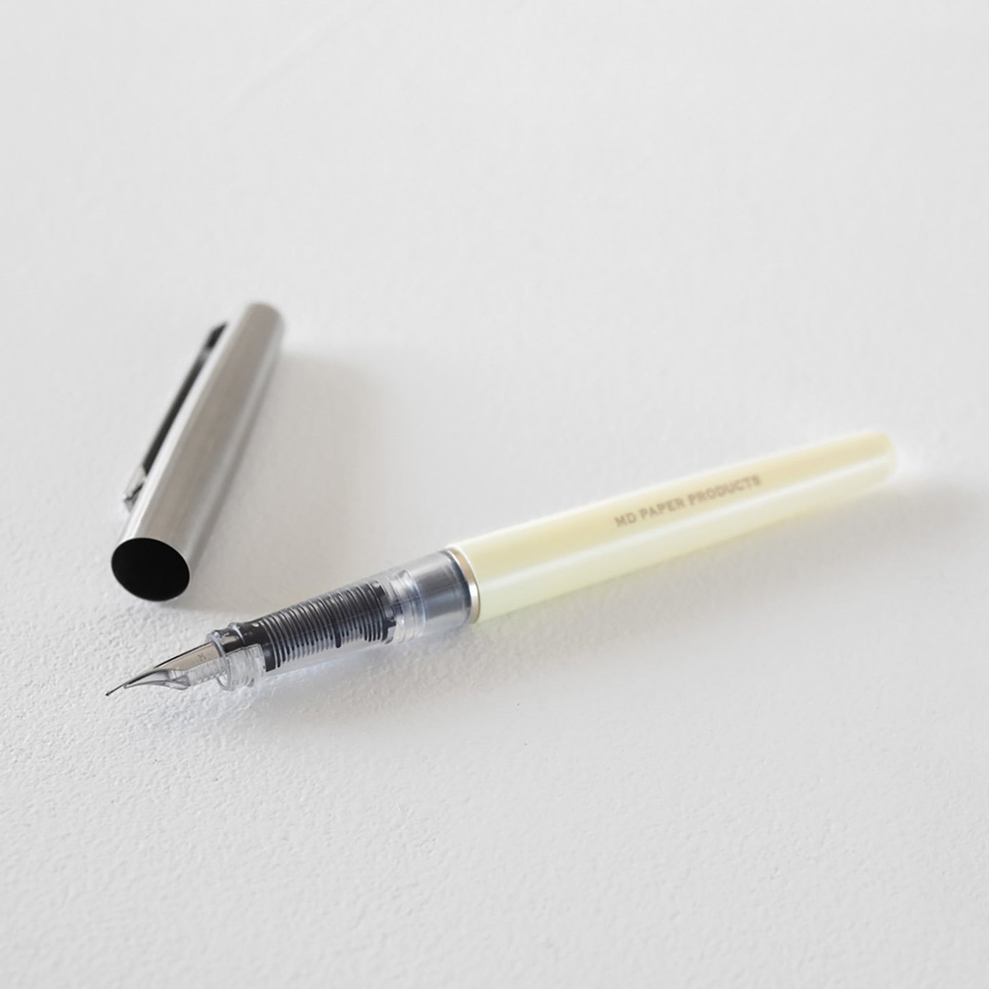 MD Product fountain pen with cream body, medium steel nib and black ink cartridge in presentation box