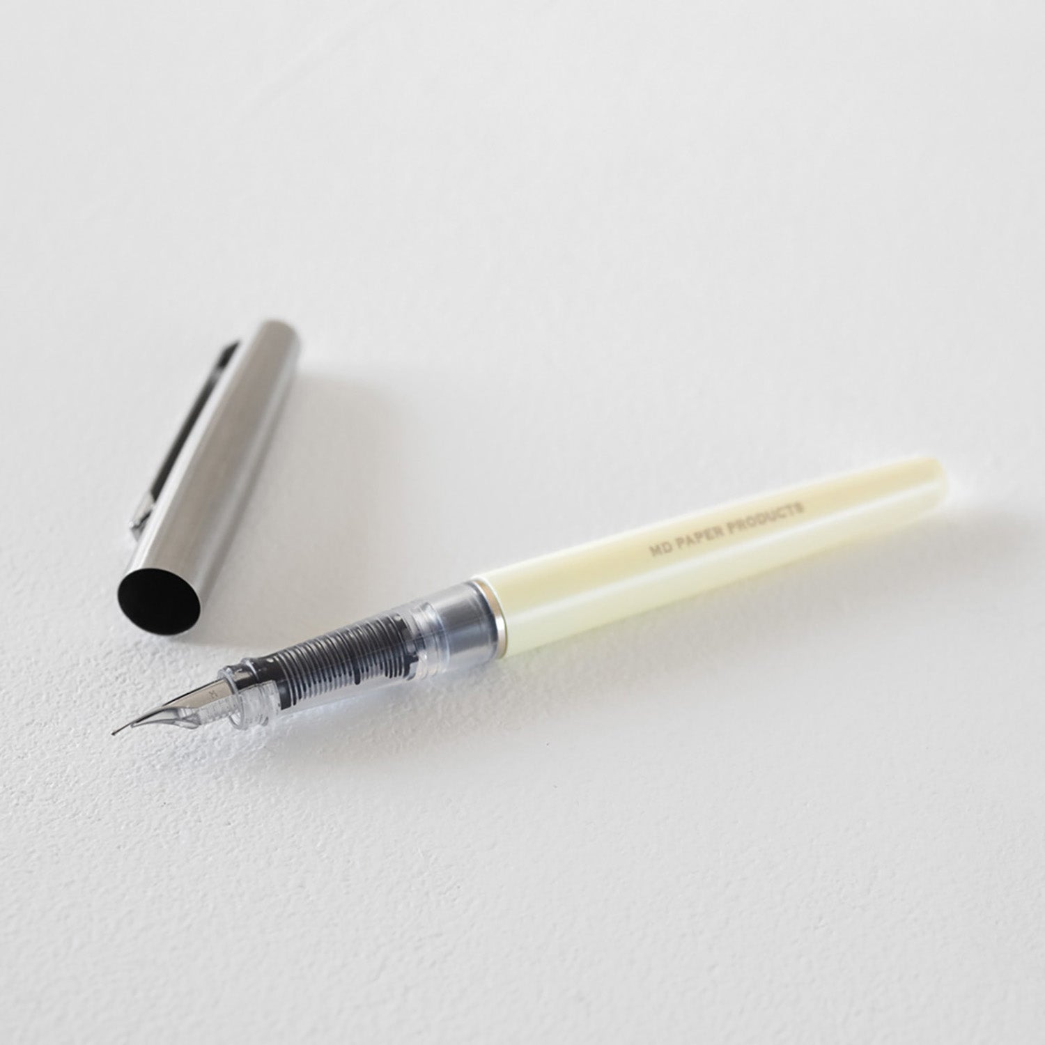 MD Product fountain pen with cream body, medium steel nib and black ink cartridge in presentation box