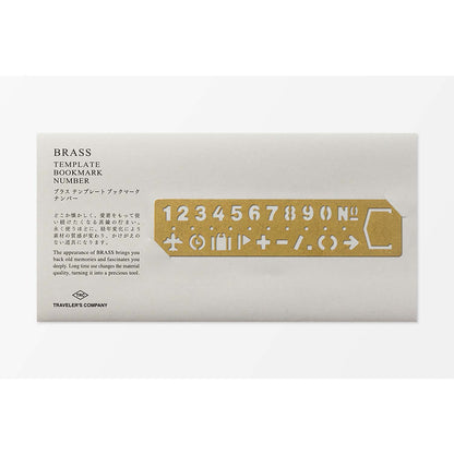 Traveler’s Company brass stencil bookmark with numbers and travel-themed icons