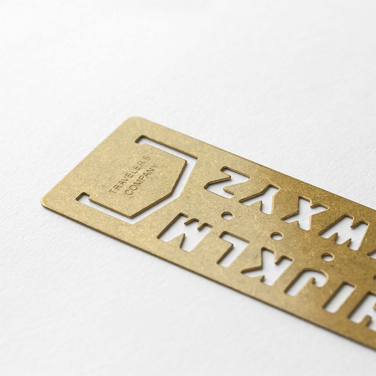 Brass stencil bookmark with uppercase A–Z letters by TRAVELER'S Company