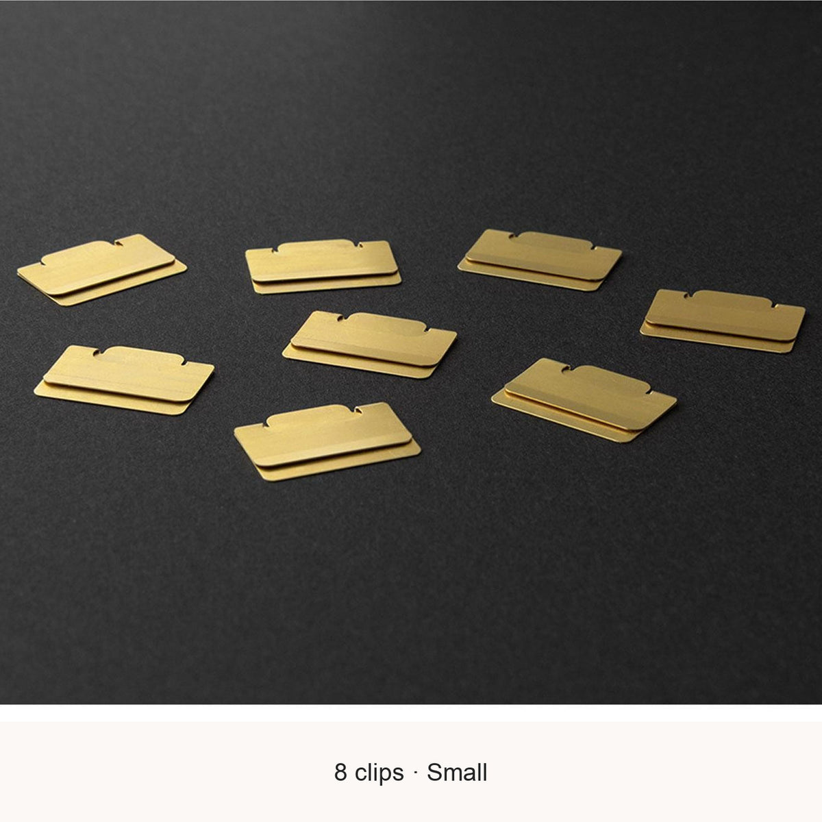 Eight Midori Chiratto small brass index clips, with English feature captions