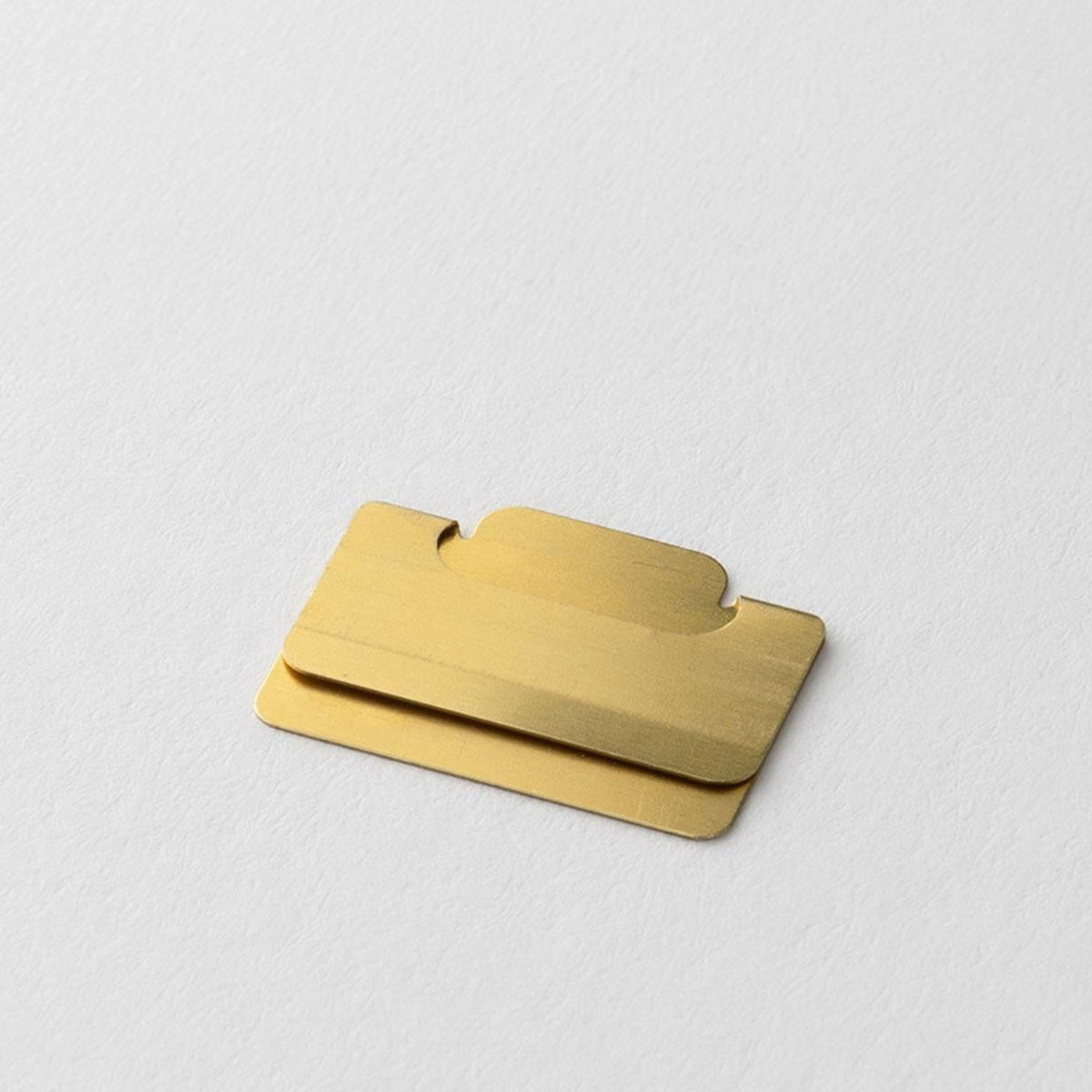 Close-up of a Midori Chiratto small brass page marker