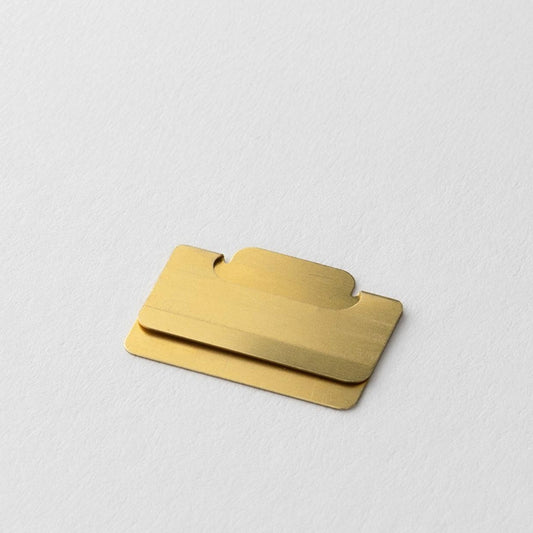 Close-up of a Midori Chiratto small brass page marker