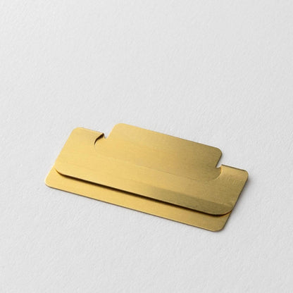 Close-up of a Midori Chiratto medium brass page marker