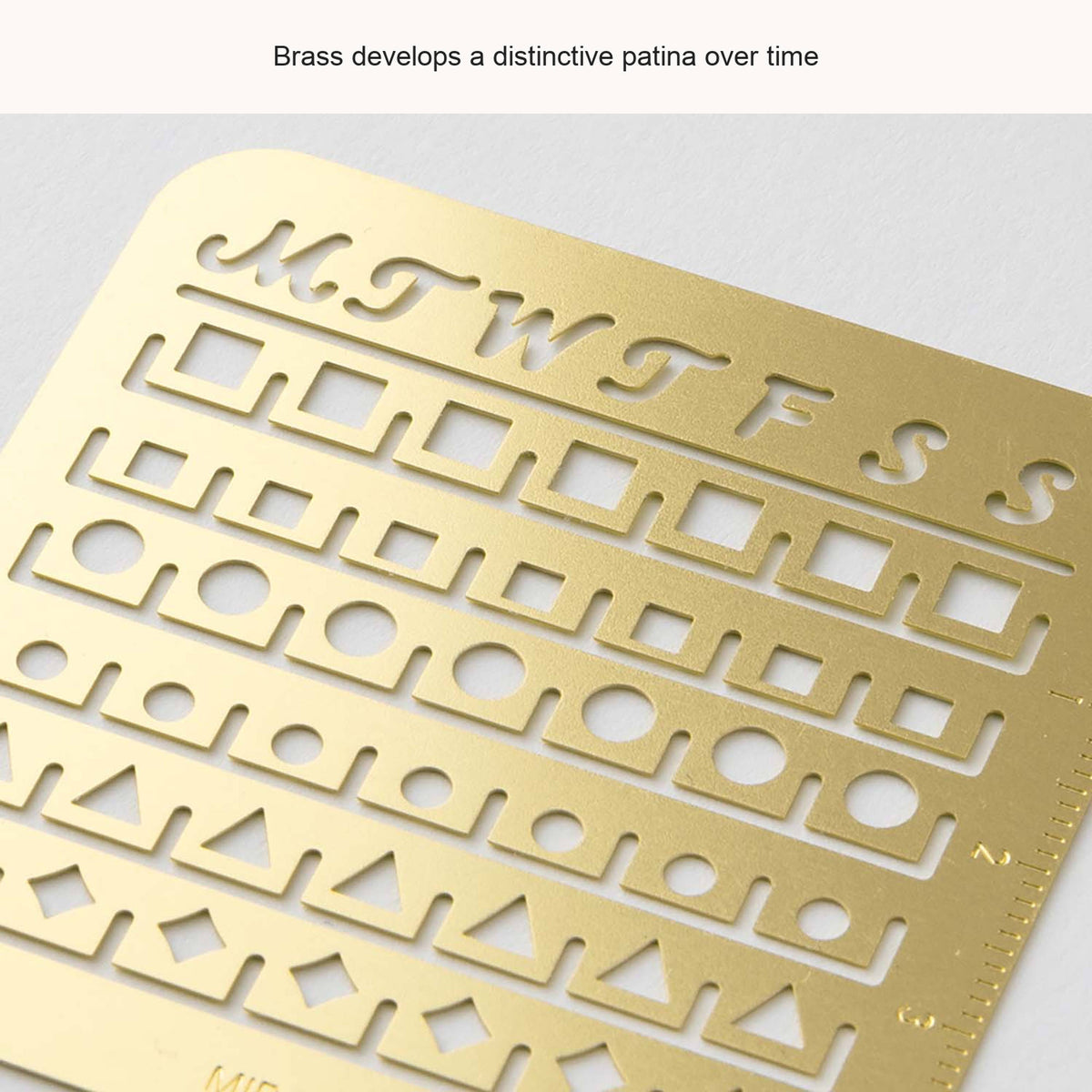 Close-up of the Midori Small brass calendar stencil, with an English caption about its patina