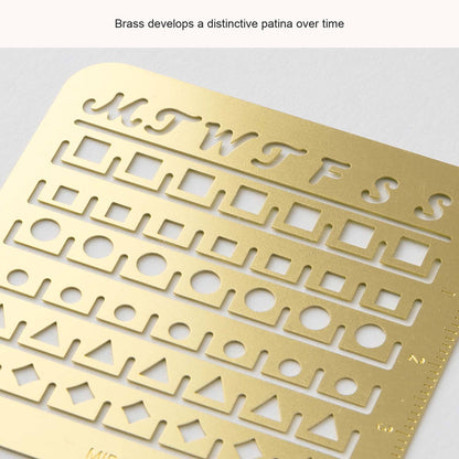 Close-up of the Midori Small brass calendar stencil, with an English caption about its patina