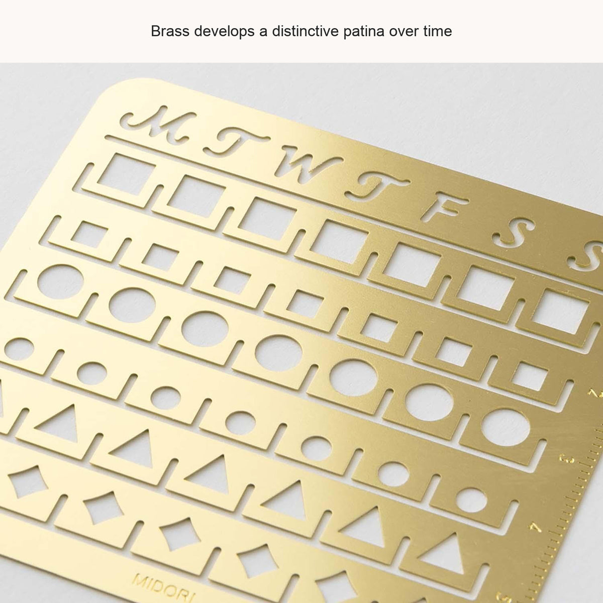 Close-up of Midori calendar stencil cut-outs, with English feature captions