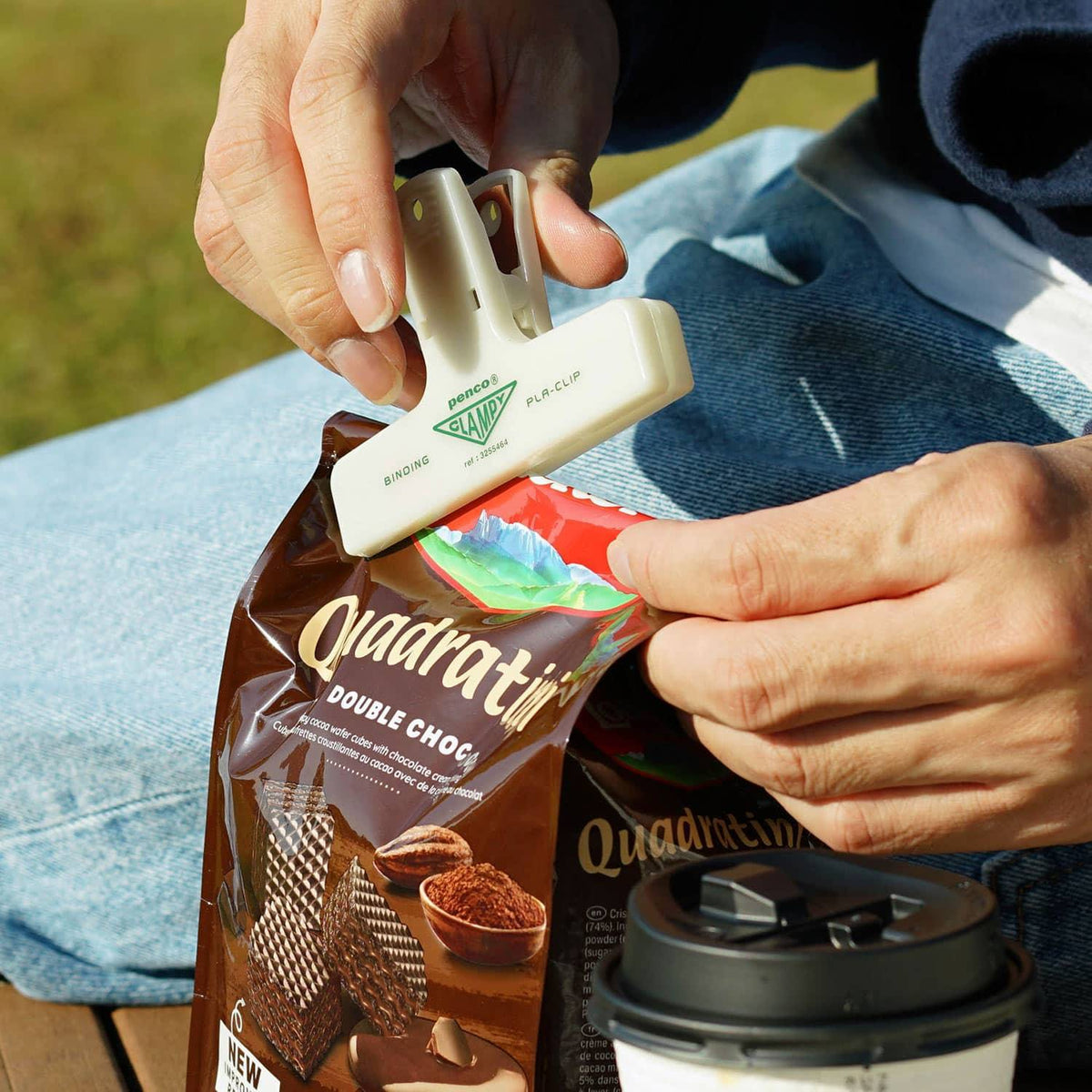 Penco glow-in-the-dark Clampy clip sealing a snack bag outdoors
