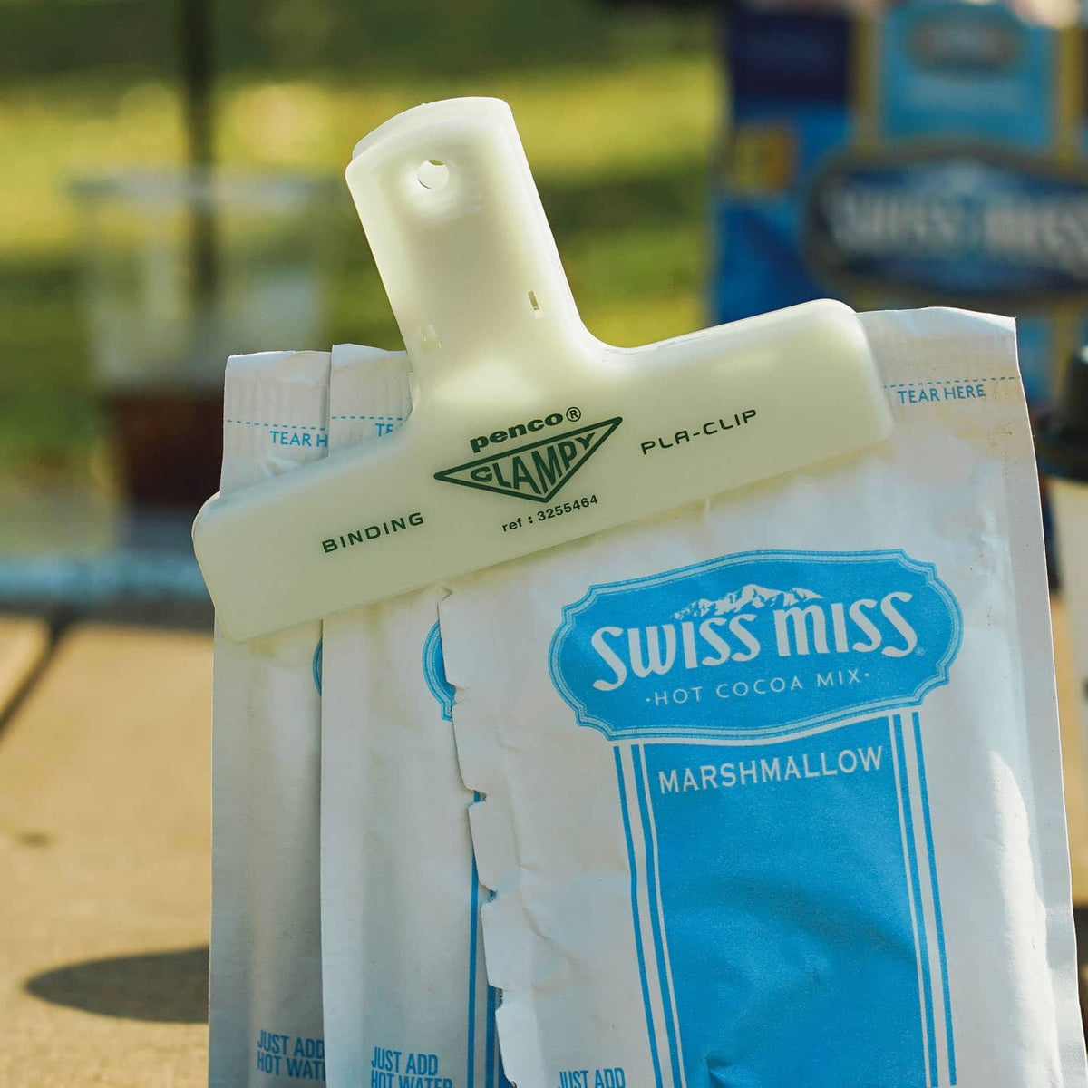Penco glow-in-the-dark Clampy clip sealing a Swiss Miss bag