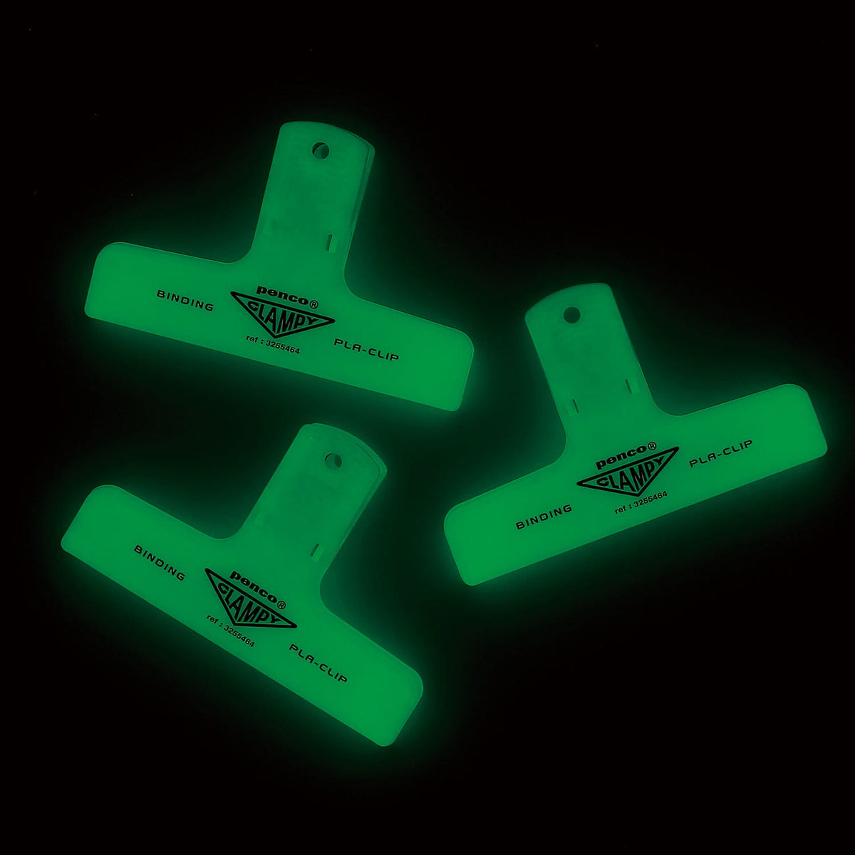 Three Penco Clampy clips glowing green in the dark