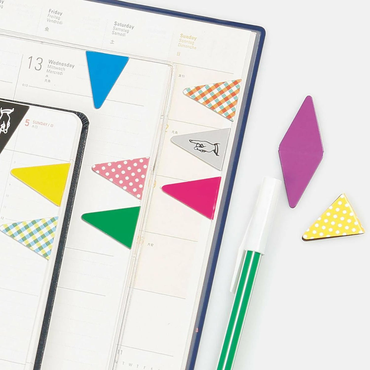Colourful Hightide magnetic markers marking notebook pages