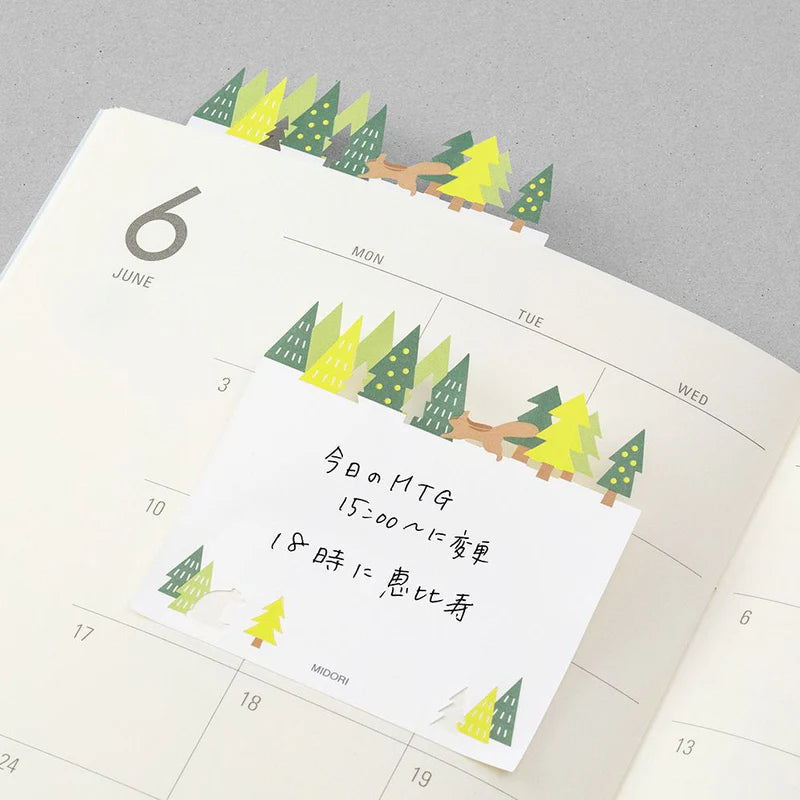 Midori sticky notes featuring a forest scene with a die-cut tree line, squirrel, and bear
