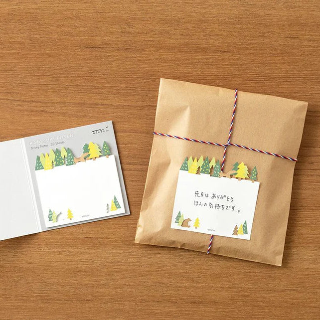 Midori sticky notes featuring a forest scene with a die-cut tree line, squirrel, and bear