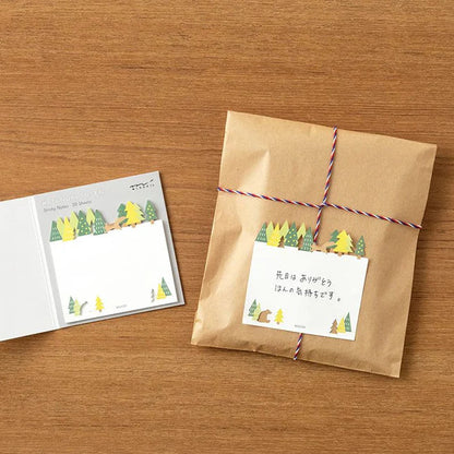 Midori sticky notes featuring a forest scene with a die-cut tree line, squirrel, and bear