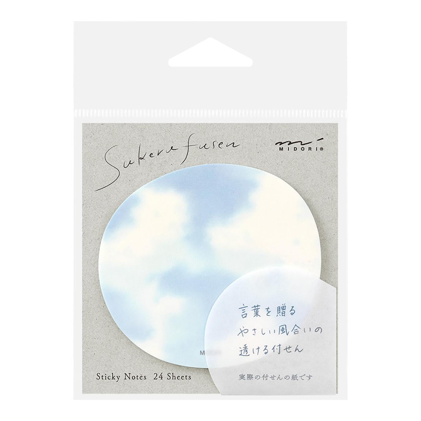 A hand peeling a translucent sticky note from a circular sky-themed pad with cloud design